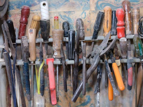 A collection of various tools neatly arranged on a workshop rack, showcasing a DIY environment.